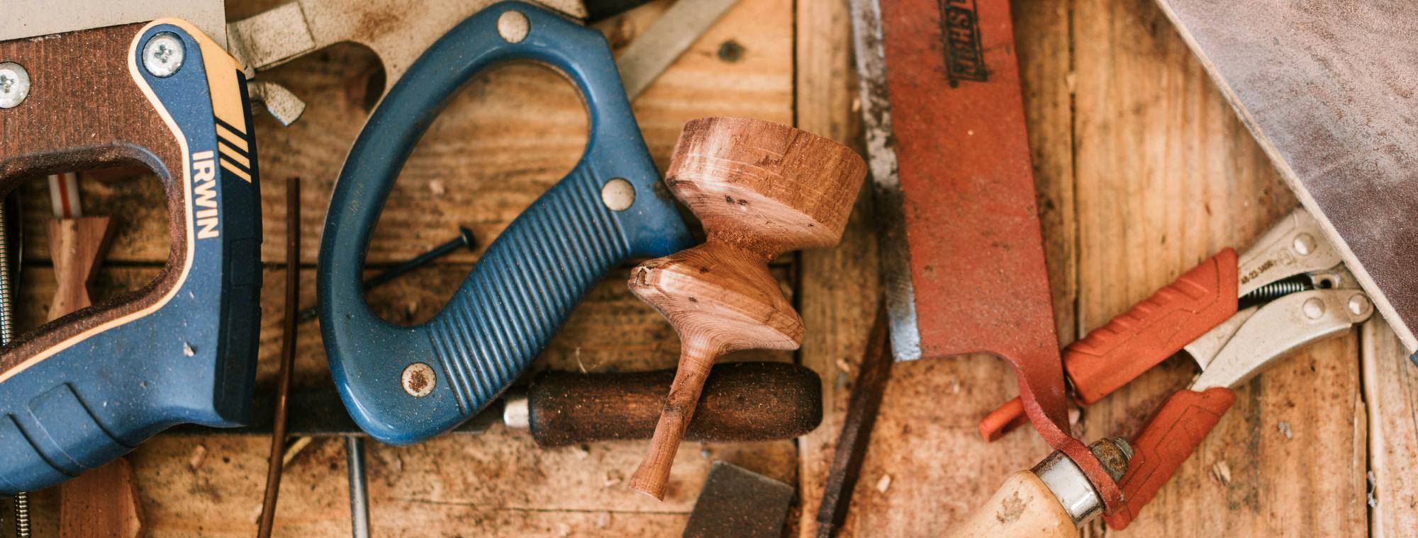 Hand tools laid out across a timber workbench